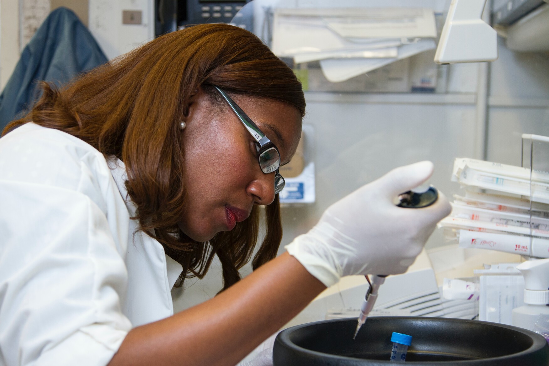 A researcher uses a pipette.